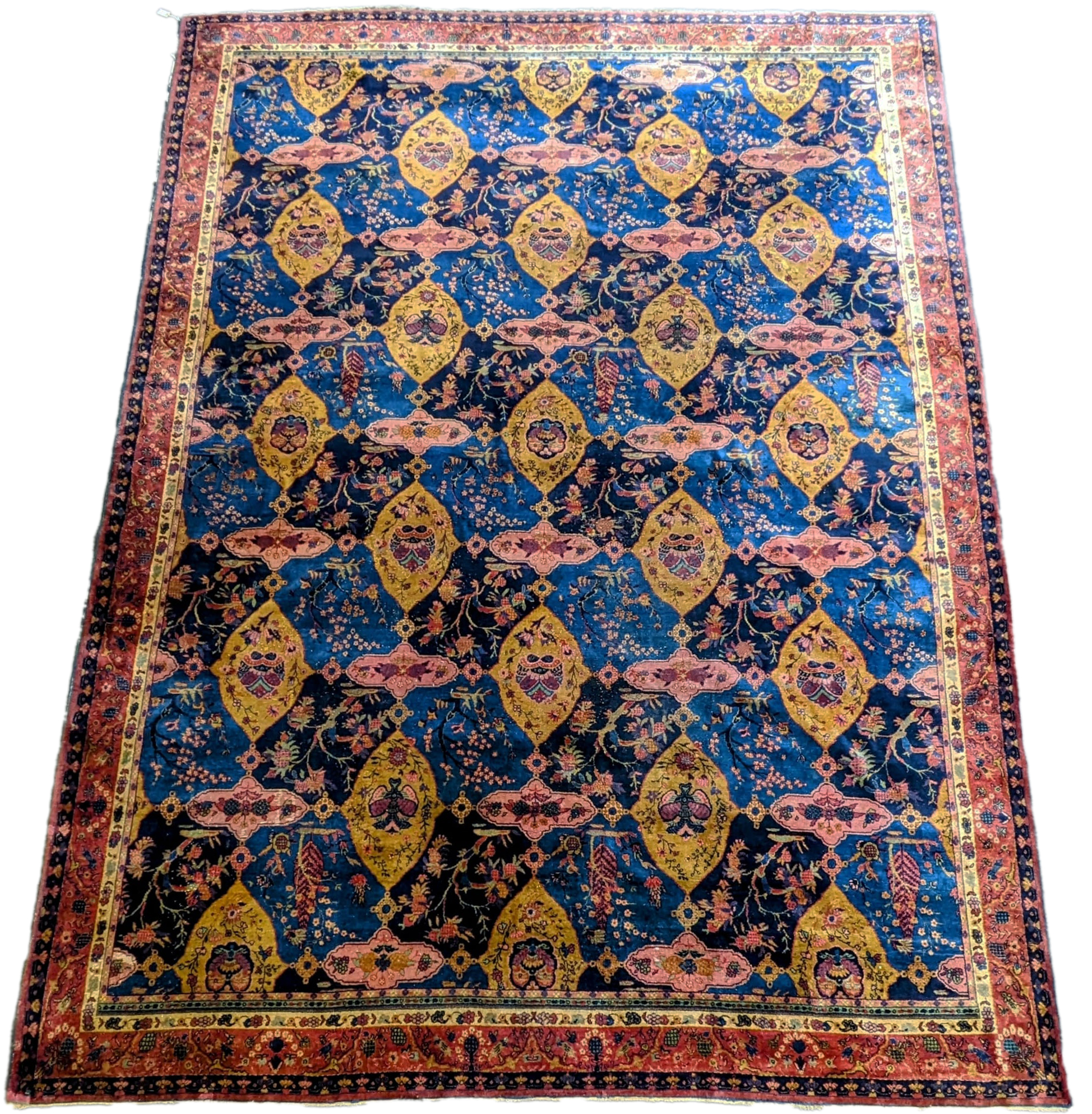 A Khorasan Mashhad red ground carpet, circa 1930’s, with field of stylised floral motif medallions, multi-bordered, 545 x 400cm. Condition - fair
